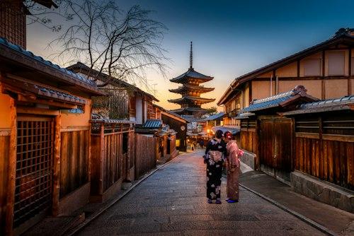 Traditional Japanese pagoda beside cherry blossoms